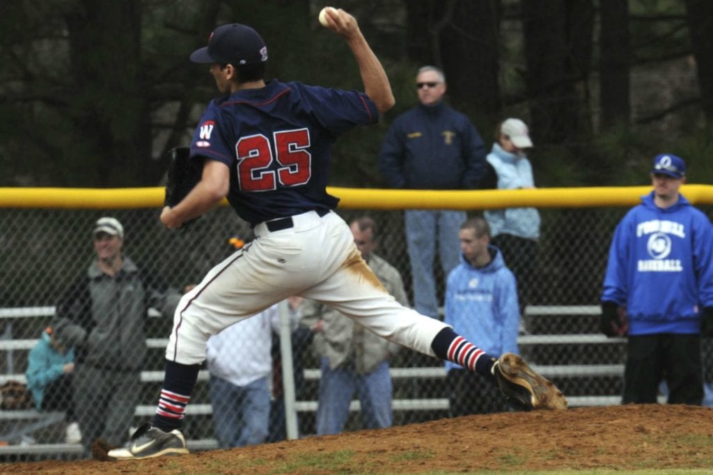 A baseball player is throwing the ball to someone.