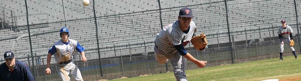 A baseball player is throwing the ball in a game.