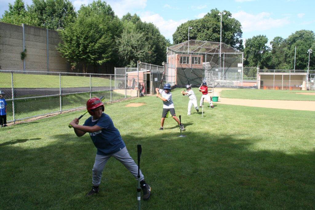 A group of people playing baseball on the field