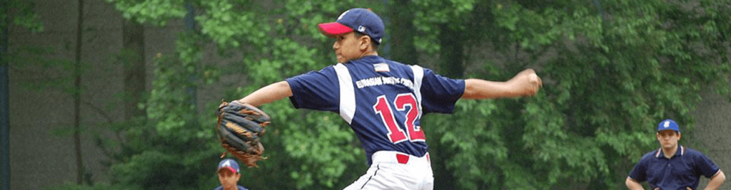 A baseball player is about to throw the ball.