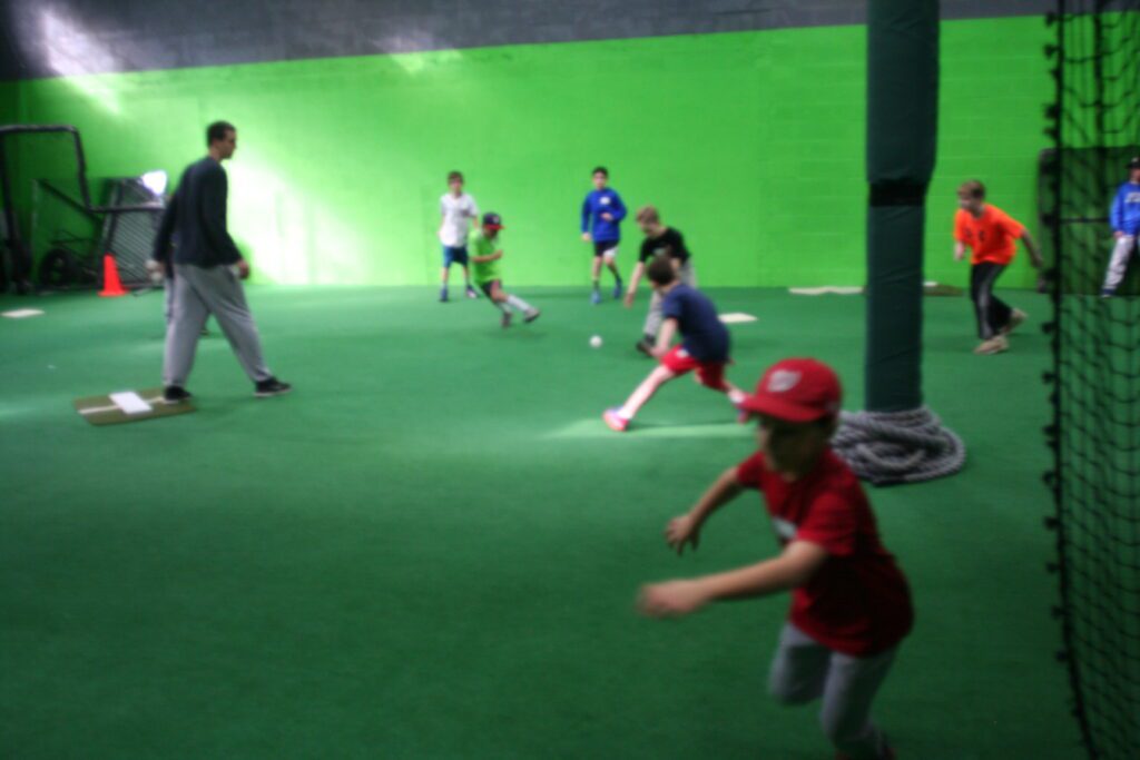 A group of kids playing baseball in the field.