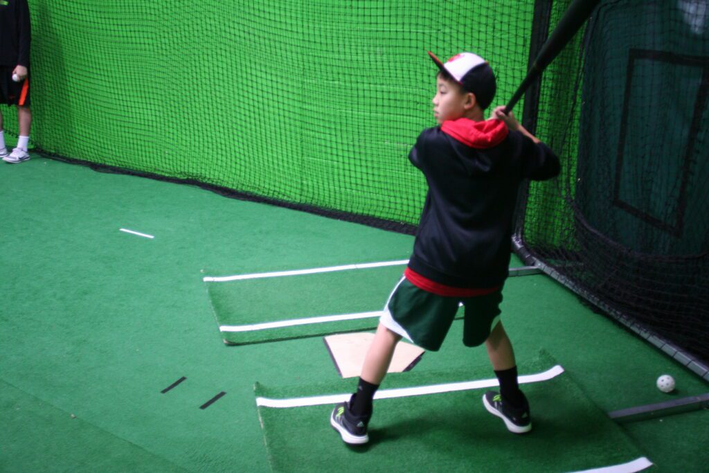 A young boy swinging at a baseball game.