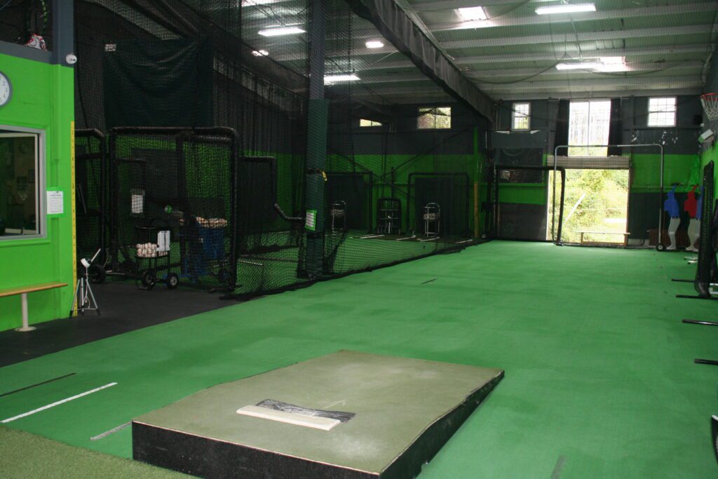 A large room with green walls and black floor.