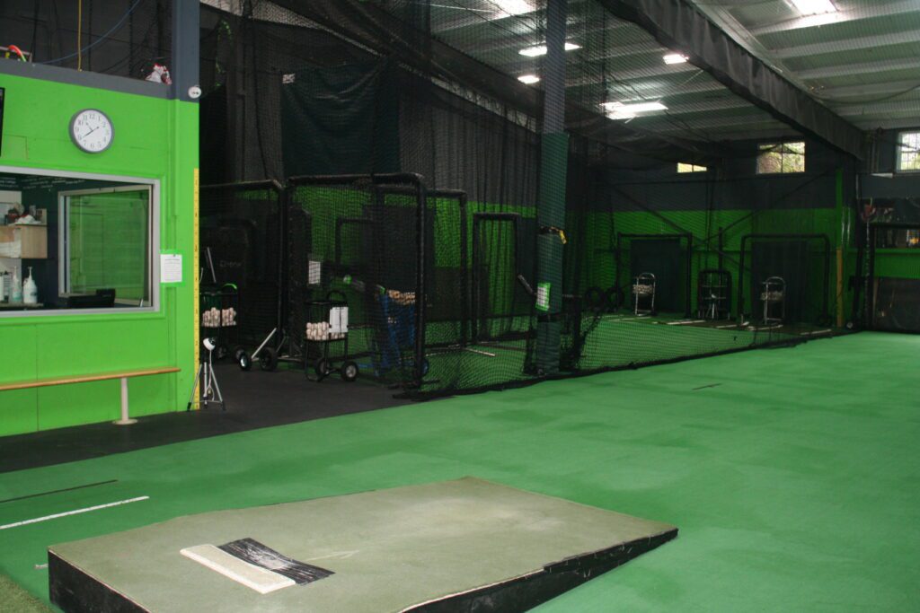 A green room with a ramp and several cages.
