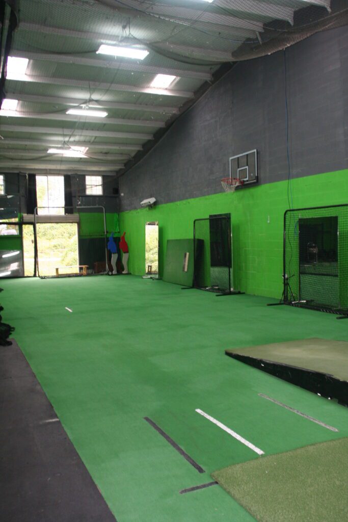 A gym with green walls and black floors
