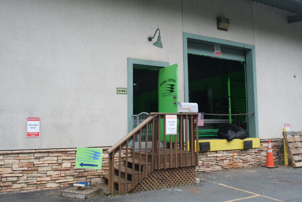 A building with stairs leading to the front door.