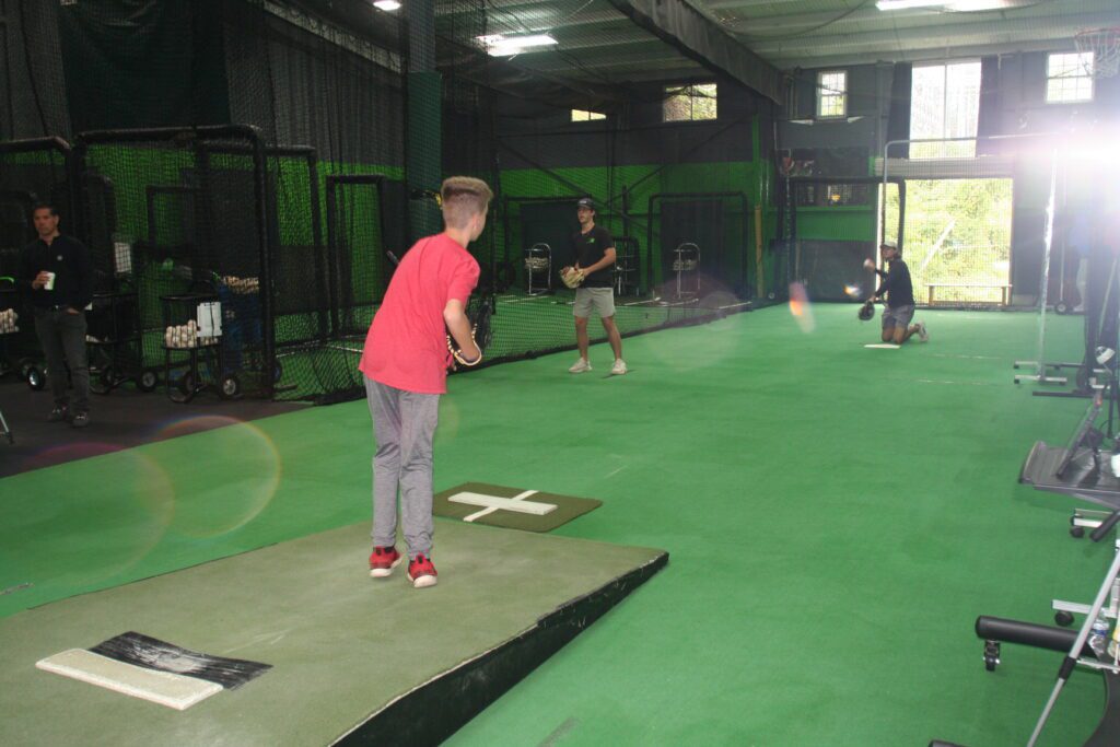 A group of people playing frisbee golf in an indoor facility.