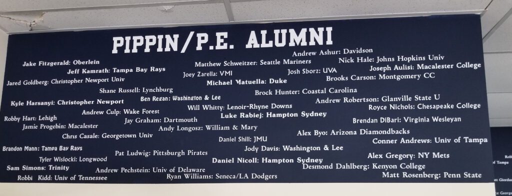 A plaque with the names of alumni in it.