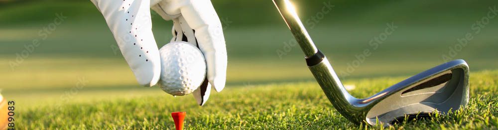 A close up of a person holding a golf ball