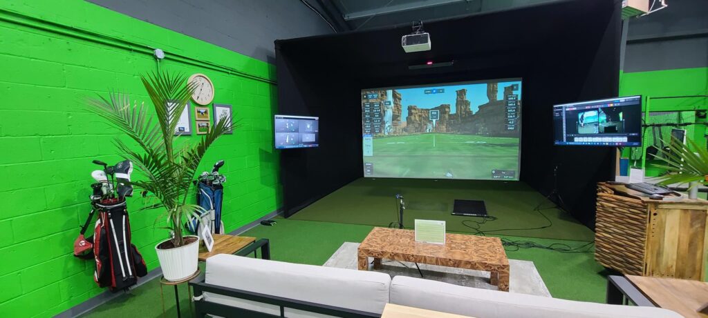 A room with a green wall and a projector